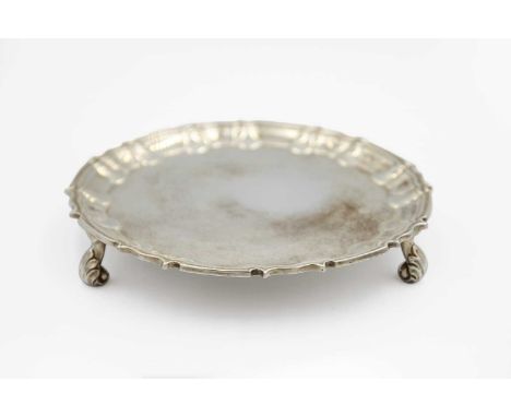 A Victorian silver card tray by William Hutton & Sons Ltd. With pie crust rim, raised on triple leaf scroll feet, London 1897