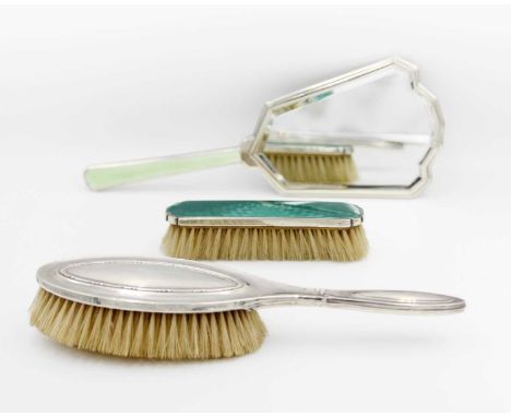 An art deco silver and enamel hand held mirror.  Indistinct marks, together with a silver backed hair brush by G &amp; C Ltd 