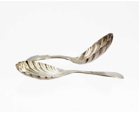 A George IV silver caddy spoon by William Eaton, and a George V caddy spoon. The William Eaton caddy spoon with scalloped bow