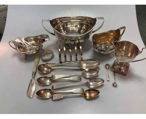 A silver two handled sugar bowl and milk jug, together with another milk jug, sauce boat, toast rack, napkin ring and assorte