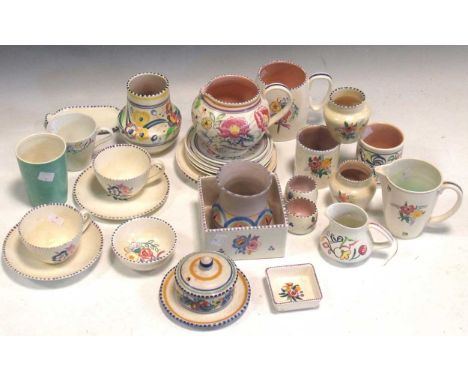 A large collection of Poole Pottery, including teacups, saucers and jugs