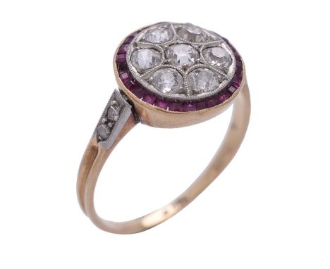 A diamond and ruby ring, the circular panel set with old brilliant cut diamonds, approximately 0.42 carats total, within a su