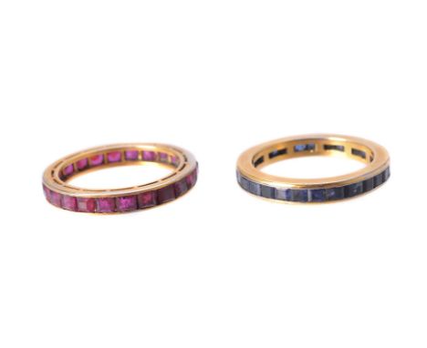 A sapphire and a ruby eternity ring, each channel set with calibré gemstones, stamped 750, finger size N, 6.6g gross