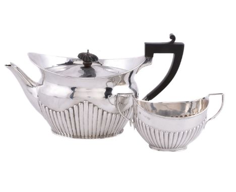 A late Victorian silver navette shape tea pot by The Goldsmiths &amp; Silversmiths Co. Ltd, London 1894, with a composition f