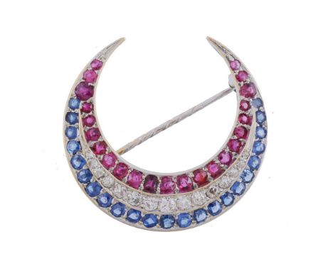 A ruby, diamond and sapphire crescent brooch, designed as a line of graduated circular cut rubies and sapphires enclosing a l