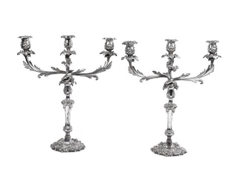 A pair of old Sheffield plate three light candelabra, unmarked, circa 1830, with detachable sconces to the shell decorated ca