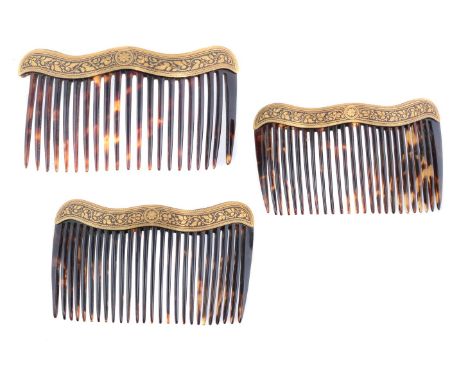 ϒA set of three late 19th century Spanish tortoiseshell haircombs, Toledo style, the combs each with a damascene mounting, in