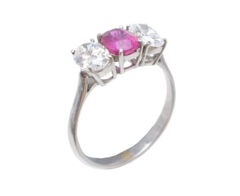 A ruby and diamond ring, the oval cut ruby, estimated to weigh 0.98 carats, claw set between two oval cut diamonds, approxima