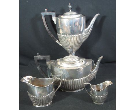 A TWO PIECE LATE VICTORIAN PART TEA SERVICE of fluted classical form with ebonised handles and finials, London hallmarks. Tog