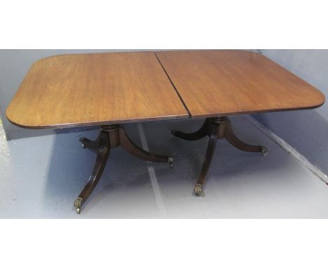 19TH CENTURY MAHOGANY TWIN PEDESTAL EXTENDING DINING TABLE with two additional leaves, standing on two tripod bases with bras