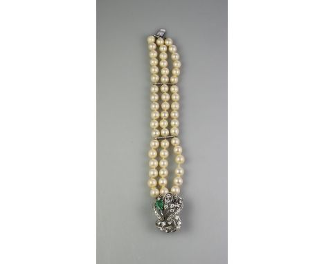 THREE STRAND CULTURED PEARL BRACELET with large diamond and emerald clasp. Length 8" (20cm) approx. (B.P. 21% + VAT) Stamped 