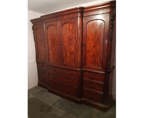 VICTORIAN MAHOGANY BREAK FRONT WARDROBE having moulded cornice above four blind panelled arch moulded doors, the projecting m