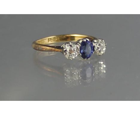 18CT GOLD THREE STONE DIAMOND AND SAPPHIRE RING. Ring size K & 1/2. Weight 2.9g approx. (B.P. 21% + VAT) Diamonds each on est