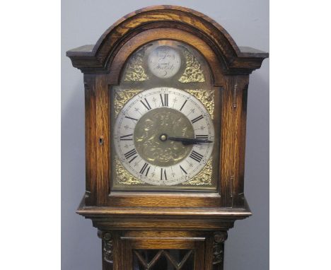 EARLY 20TH CENTURY STAINED OAK LONGCASE CLOCK having arched hood above brass face with silvered Roman chapter ring, glazed wa