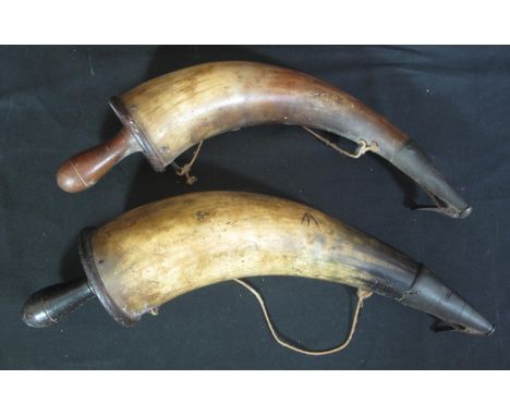 TWO SIMILAR 19TH CENTURY COW HORN MILITARY POWDER FLASKS with turned wooden caps and metal fixings. One with military arrow a