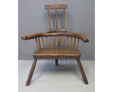 PRIMITIVE OAK, ASH AND ELM COMB BACKED STICK BACKED ELBOW CHAIR having solid seat on three legs. 87cm wide approx. (B.P. 21% 