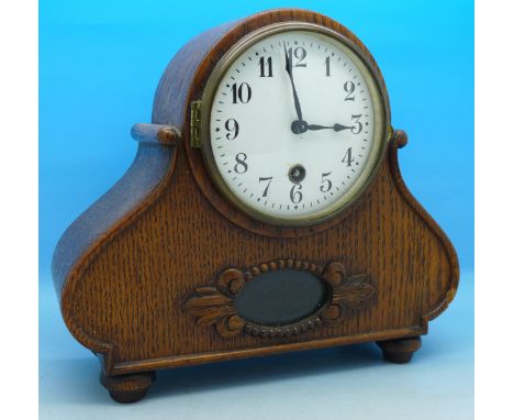 An oak cased mantel clock