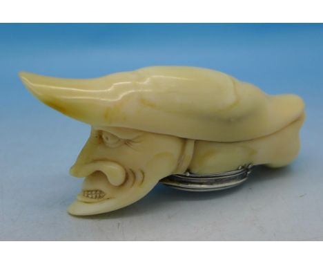 A carved double headed ivory and white metal mounted snuff box, 84mm