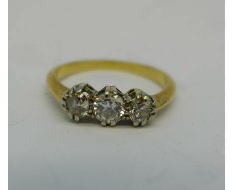 A yellow metal and three stone diamond ring, 2.5g, L