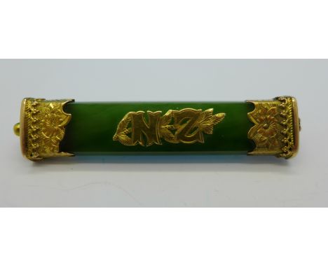 A yellow metal and jade 'New Zealand' brooch, 6cm