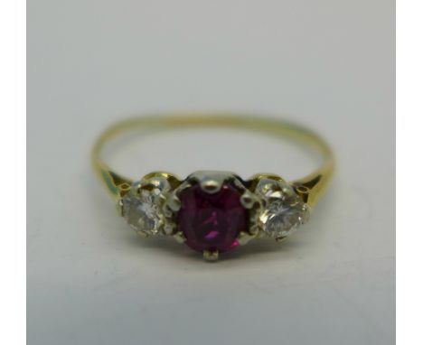 An 18ct gold and three stone ruby and diamond ring, 1.8g, O