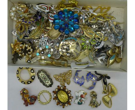 Costume brooches in a biscuit tin in the form of a trunk