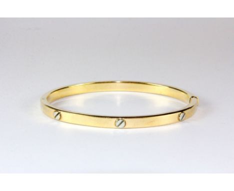 A 9ct yellow gold hinged bangle.