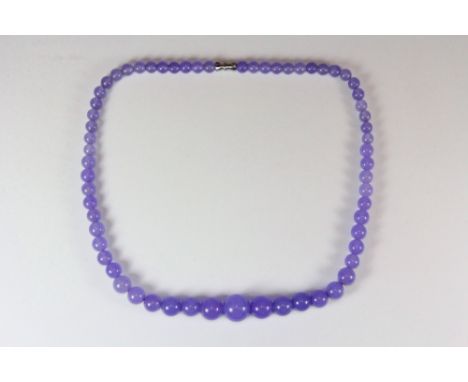 A graduated lavender jade necklace, L. 45cm.