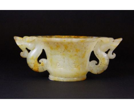 A lovely Chinese carved jade libation cup with dragon handles, W. 13cm, H. 5cm. Probably early 20th century.