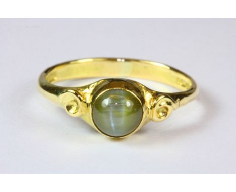 A 9ct gold ring set with tigers eye, (M).