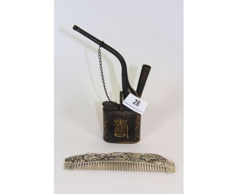 A Chinese opium pipe and a white metal comb.