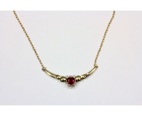 A 9ct gold diamond and heart shaped synthetic ruby necklace.