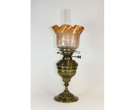 A Victorian brass oil lamp and shade.