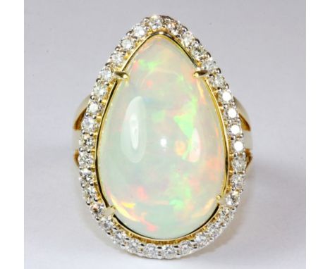 A magnificent 18ct yellow gold ring set with a large opal (approx. 12.3ct) surrounded by (approx 1ct) diamonds (P). Est. £1,2