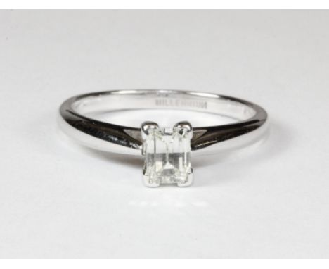 An 18ct white gold ring set with a princess shaped solitaire diamond with an unusual multi-faceted curved table (K).