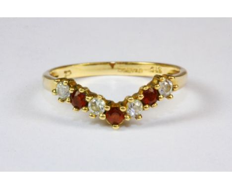 A 9ct yellow gold ruby and zirconia wishbone ring, (J.5).
