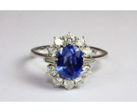 An 18ct white gold ring set with a Ceylon sapphire surrounded by diamonds (P). Est. £400 - 600