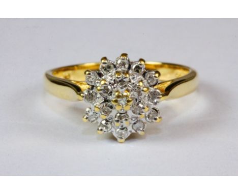An 18ct yellow gold diamond cluster ring, (J.5).