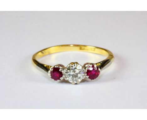 An 18ct yellow gold and platinum three stone ruby and diamond ring (Q).