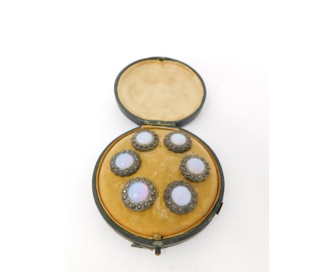 A cased set of Georgian opal foil glass and cut steel waistcoat buttons. A set of six in a green leather effect fitted circul