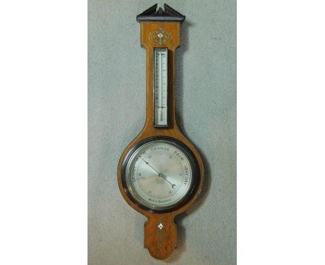 A late 19th century mahogany aneroid barometer with ebony and pewter stringing and floral mother of pearl inlay. 85x28cm