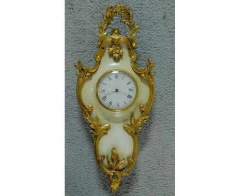A gilt metal and marble effect painted wooden miniature Cartel clock in the Rococo style with white enamel dial, Roman numera