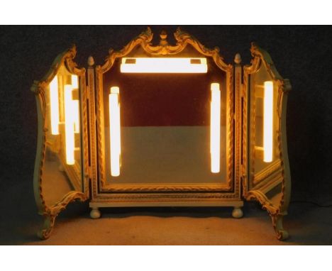 A mid century cream and gilt Rococo style triptych dressing mirror with later wired vanity lighting. H.71 W.110cm 