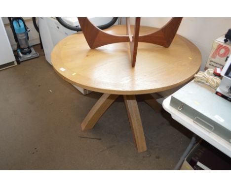 A light oak circular top dining table