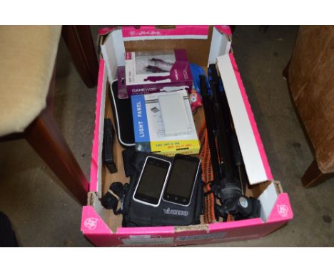 A box containing a camera tripod; two Nintendo DSs; mobile phones etc