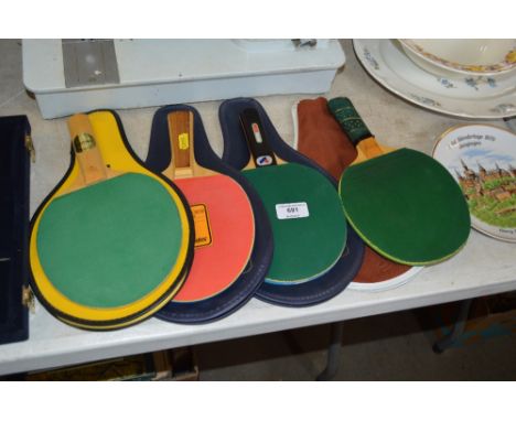 Four table tennis bats and cases