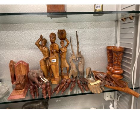 SHELF OF CARVED TRIBAL ART WARE INCLUDING FIGURES, VASES, BOOKENDS