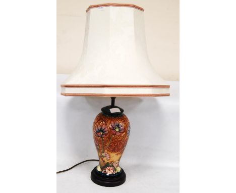 Moorcroft table lamp decorated with tube-lined flowers on a turquoise ground, 28cm high, with shade. 