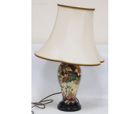 Moorcroft table lamp decorated with tube-lined flowers on a cream and blue ground, 28cm high, with shade. 