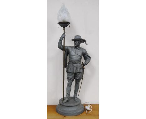 After Auguste Poitevin Spelter table lamp modelled as a standing Cavalier holding a torch aloft with his right hand, with gla